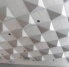 Acoustic ceiling design featuring geometric tiles, showcasing craftsmanship related to Framing to Drywall's services in drywall installation and acoustic solutions.